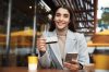 Online payment and shopping concept. Businesswoman sitting in cafe with credit card and mobile phone, purchase something in internet or transfer money.